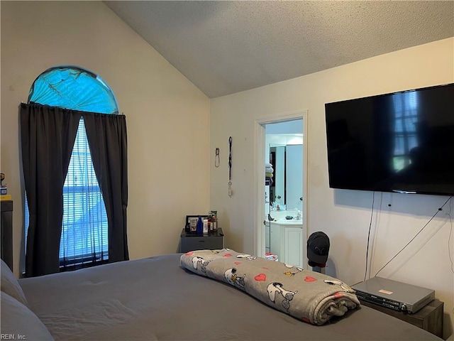 bedroom with ensuite bath and vaulted ceiling