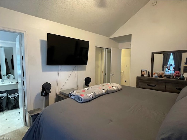 bedroom with light colored carpet, connected bathroom, vaulted ceiling, and a closet