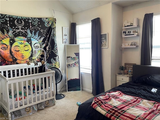 bedroom with lofted ceiling, multiple windows, and carpet