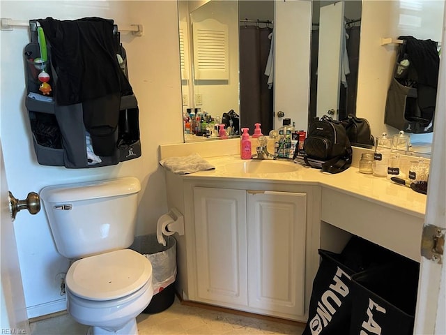 bathroom featuring toilet and vanity