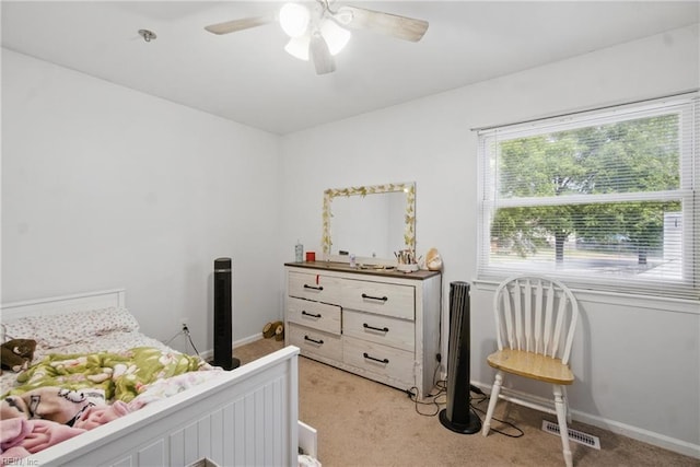 bedroom with baseboards, visible vents, light carpet, and ceiling fan