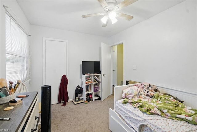 bedroom featuring ceiling fan and light colored carpet