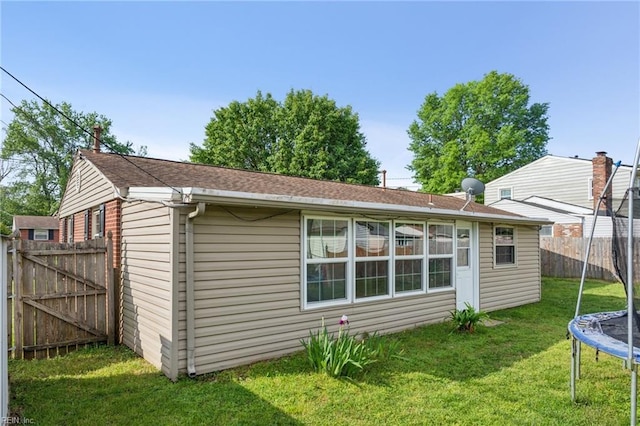 2015 Neville Cir, Hampton, VA 23663 - back of property featuring a trampoline, fence, and a yard