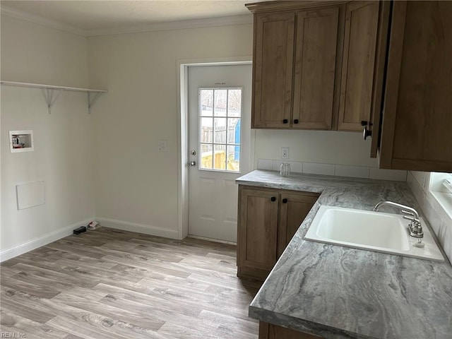 1216 Skylark Dr, Virginia Beach, VA 23453 - laundry area with light wood finished floors, washer hookup, a sink, crown molding, and cabinet space