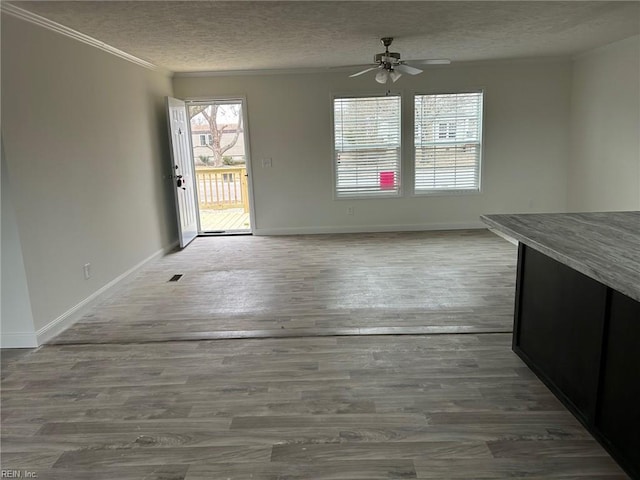 1216 Skylark Dr, Virginia Beach, VA 23453 - unfurnished dining area with a textured ceiling, baseboards, a ceiling fan, and ornamental molding