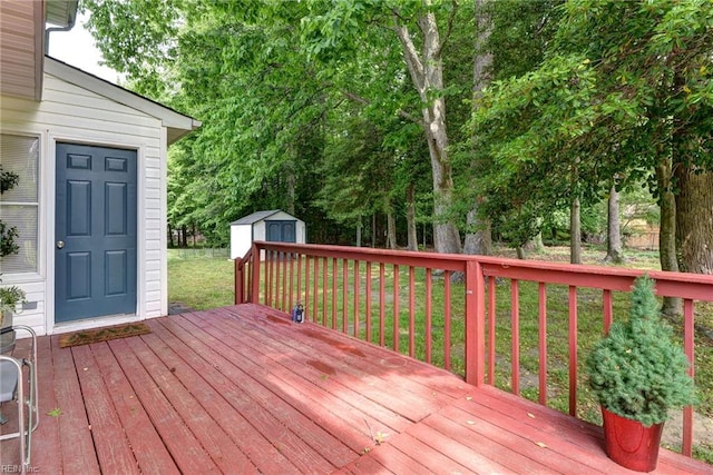 wooden deck with a shed, an outdoor structure, and a yard