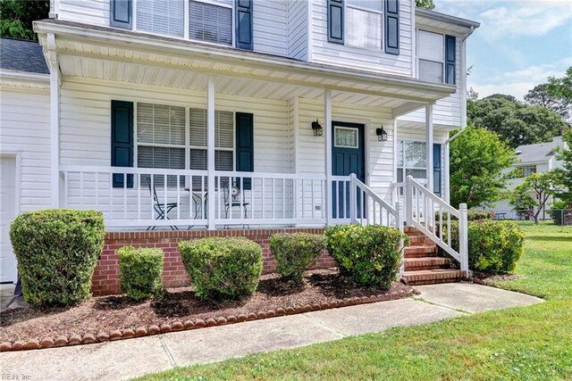 view of exterior entry featuring a porch