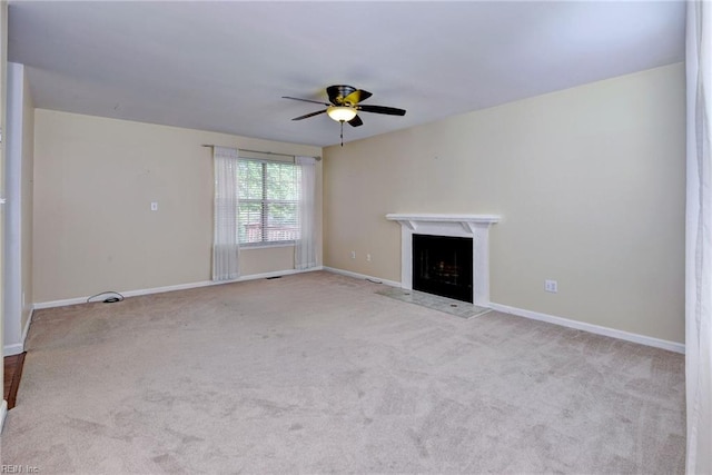 unfurnished living room with a ceiling fan, carpet floors, a fireplace, and baseboards
