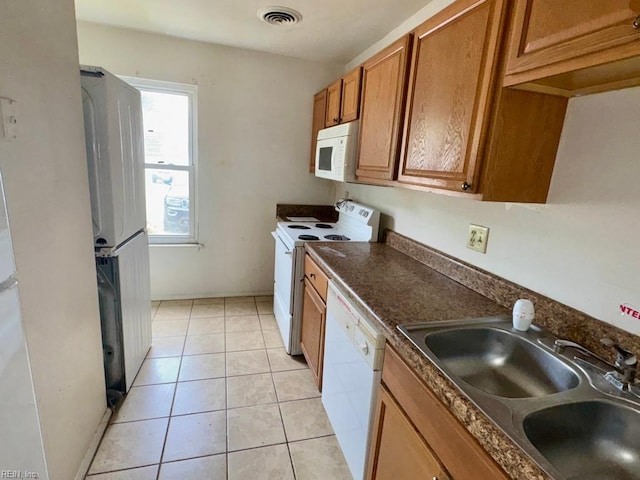 1528 Darren Cir, Portsmouth, VA 23701 - kitchen with visible vents, dark countertops, brown cabinets, a sink, and white appliances