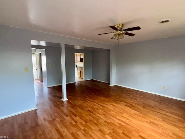 1528 Darren Cir, Portsmouth, VA 23701 - unfurnished room with baseboards, a ceiling fan, and wood finished floors