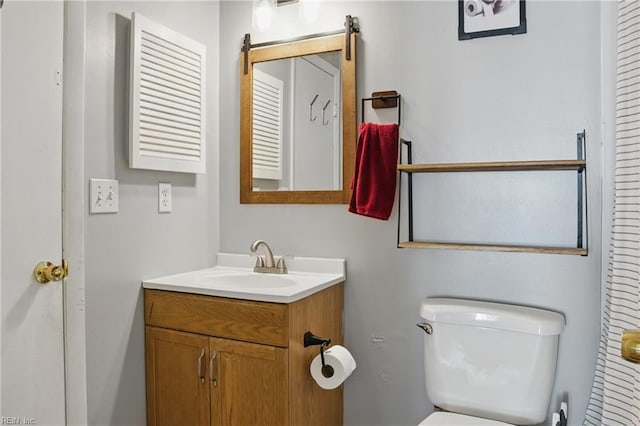 bathroom featuring toilet and vanity
