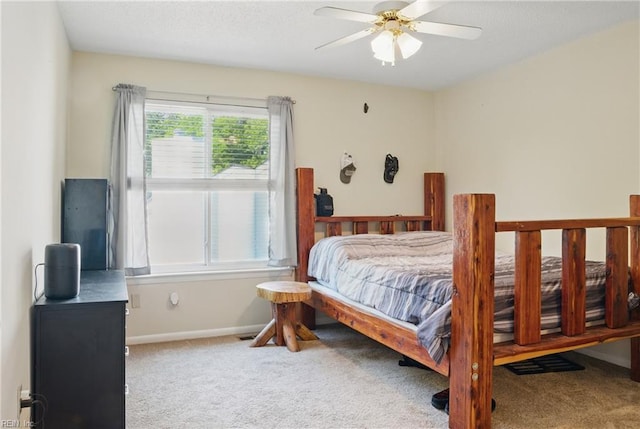 bedroom featuring carpet floors, baseboards, and a ceiling fan