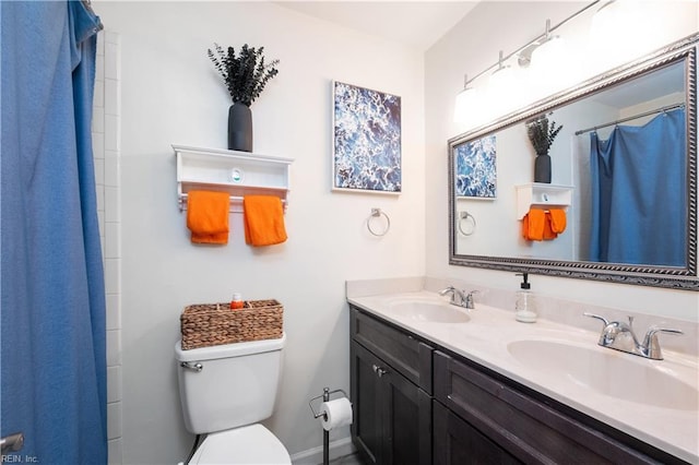 full bath with double vanity, toilet, a shower with shower curtain, and a sink