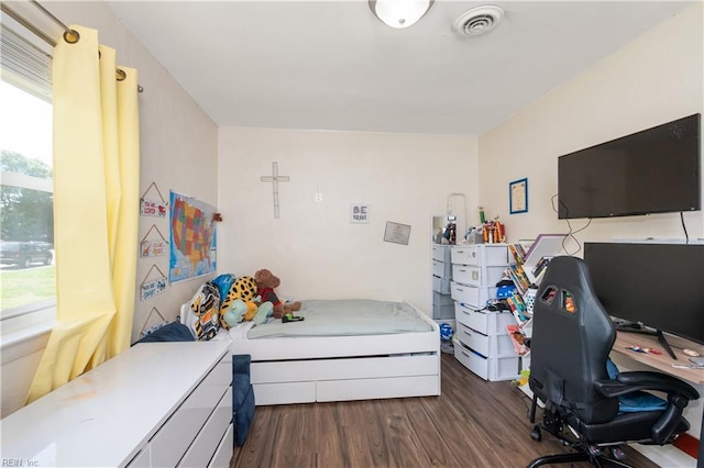 bedroom with visible vents and dark wood-style floors