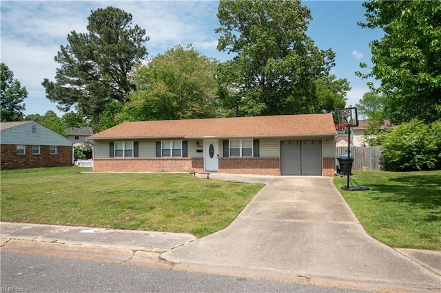 single story home featuring a garage, a front yard, driveway, and brick siding