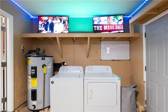 laundry room featuring washing machine and clothes dryer, laundry area, and electric water heater