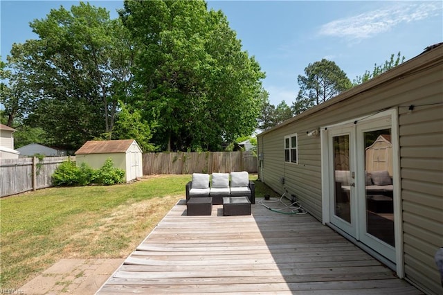wooden deck with a fenced backyard, a storage unit, a yard, and outdoor lounge area