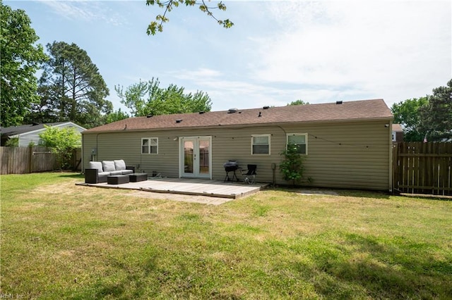 back of property featuring a deck, outdoor lounge area, a fenced backyard, french doors, and a lawn