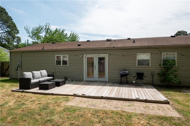 rear view of property featuring an outdoor living space, a lawn, french doors, and a deck