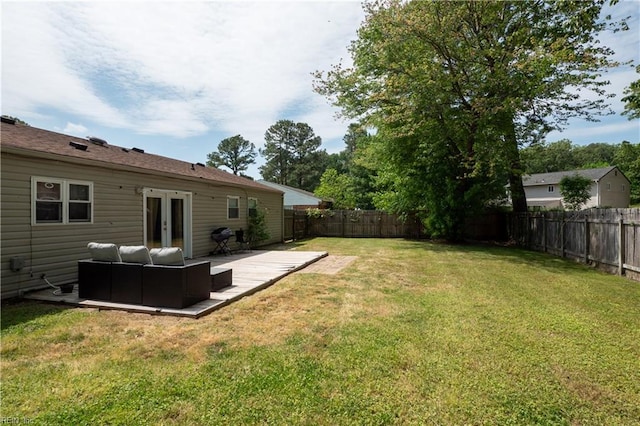 view of yard with a fenced backyard, an outdoor hangout area, and french doors