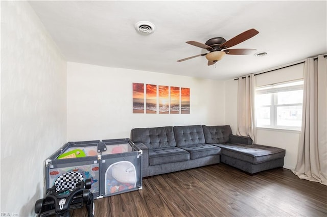 living room featuring a ceiling fan, wood finished floors, and visible vents