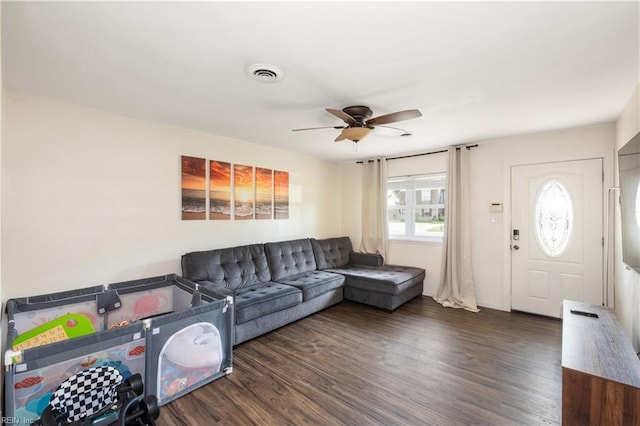 living room with visible vents, ceiling fan, and wood finished floors