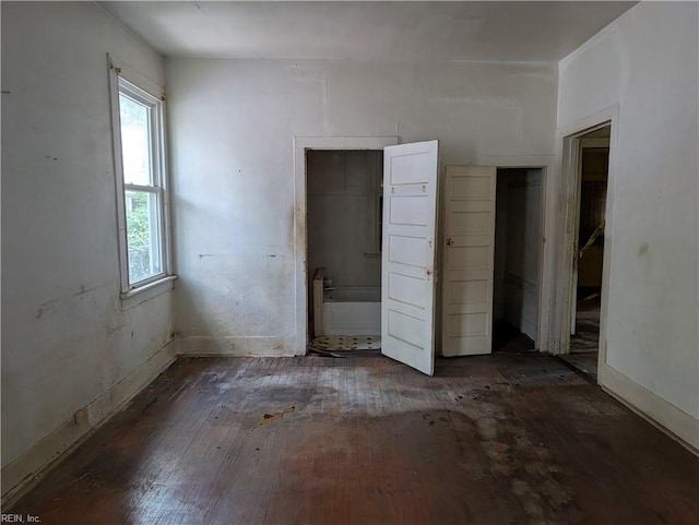 unfurnished bedroom featuring baseboards and hardwood / wood-style flooring