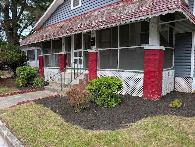 exterior space with a sunroom and entry steps