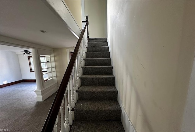 stairway with baseboards, a ceiling fan, and carpet flooring