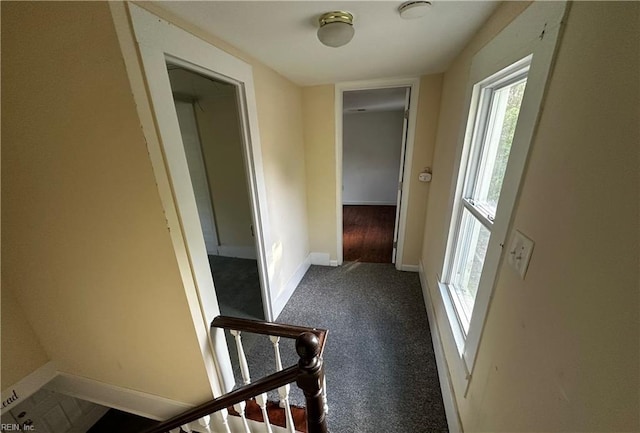 corridor featuring carpet floors and baseboards