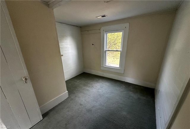 carpeted empty room with visible vents and baseboards