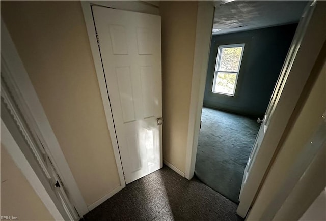 hallway featuring baseboards
