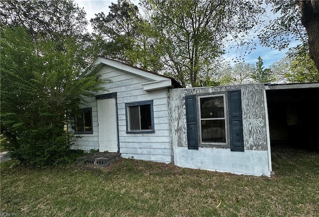 view of property exterior featuring a lawn