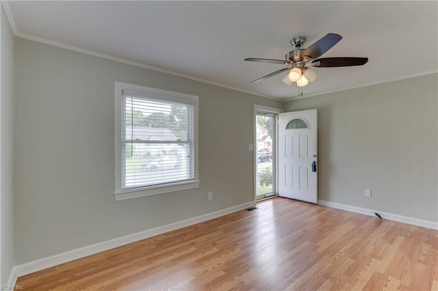 foyer with baseboards, ceiling fan, ornamental molding, and light wood-type flooring