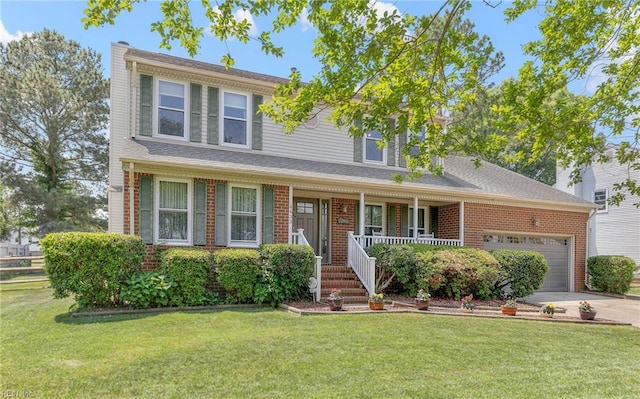 traditional-style house with an attached garage, a front lawn, a porch, and driveway
