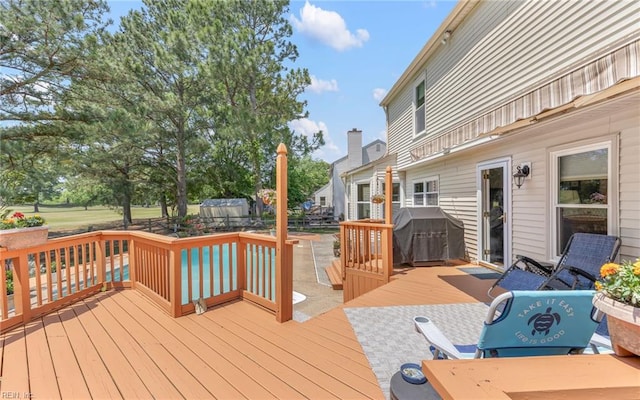 wooden deck with a grill