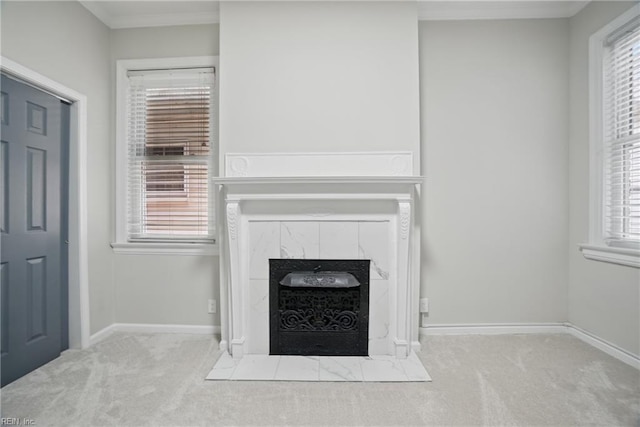 details featuring carpet floors, a premium fireplace, baseboards, and ornamental molding