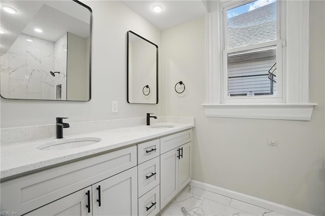 bathroom featuring a sink, baseboards, double vanity, and marble finish floor