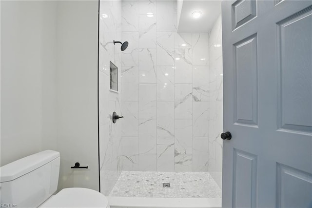 full bathroom with toilet and tiled shower
