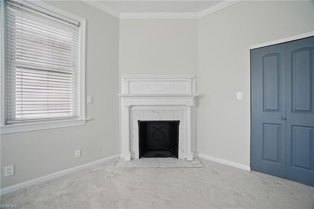 unfurnished living room with carpet flooring, baseboards, a tiled fireplace, and ornamental molding