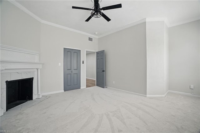 unfurnished living room with carpet floors, ceiling fan, visible vents, and ornamental molding