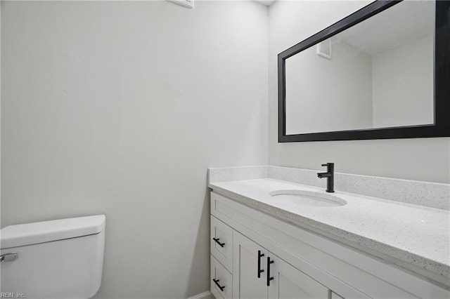 bathroom with toilet and vanity