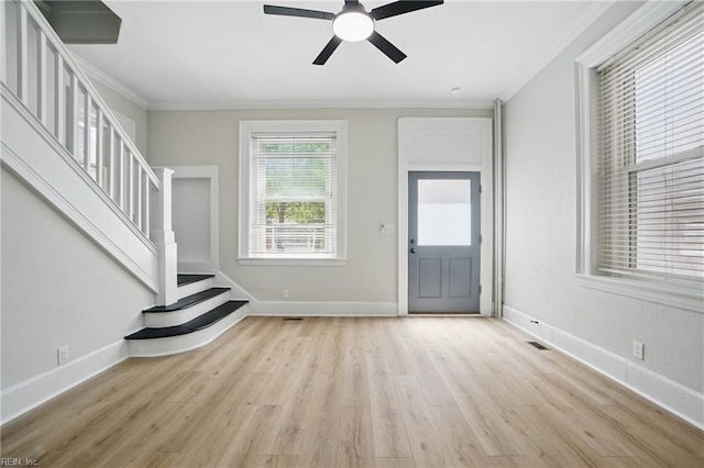 foyer entrance featuring ceiling fan, stairs, baseboards, light wood-type flooring, and ornamental molding