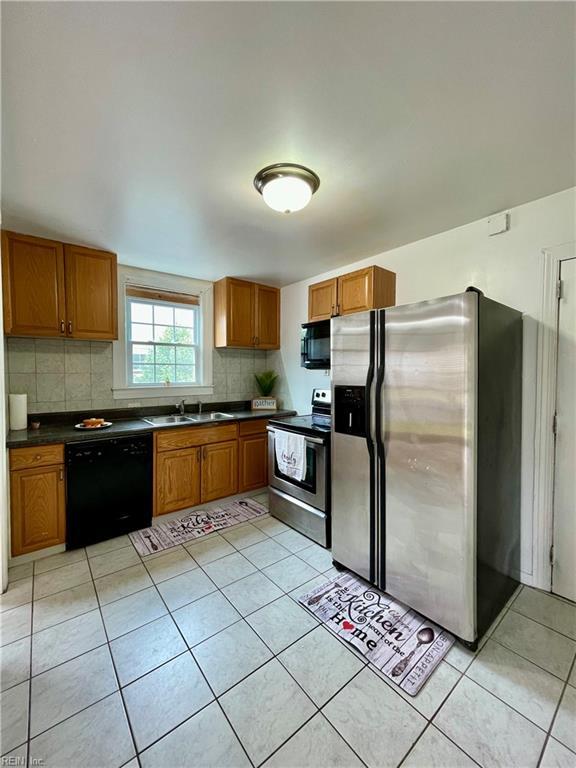 222 Chesterfield Rd, Hampton, VA 23661 - kitchen with black appliances, a sink, dark countertops, and brown cabinets