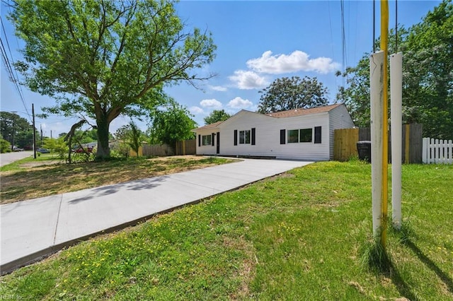 single story home with fence and a front lawn