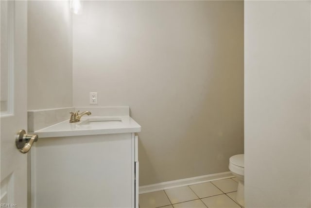 bathroom featuring toilet, baseboards, tile patterned flooring, and vanity