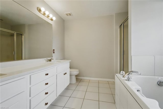 bathroom with double vanity, tile patterned floors, a sink, and a stall shower
