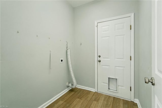 laundry room with baseboards, hookup for an electric dryer, laundry area, and wood finished floors