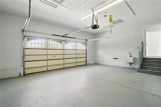 garage featuring a sink and a garage door opener