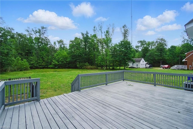 wooden terrace featuring a lawn
